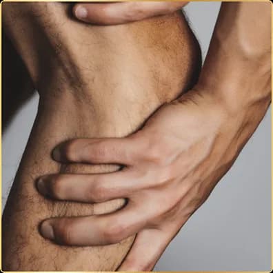 A person gripping their lower calf with one hand, as if easing an ache